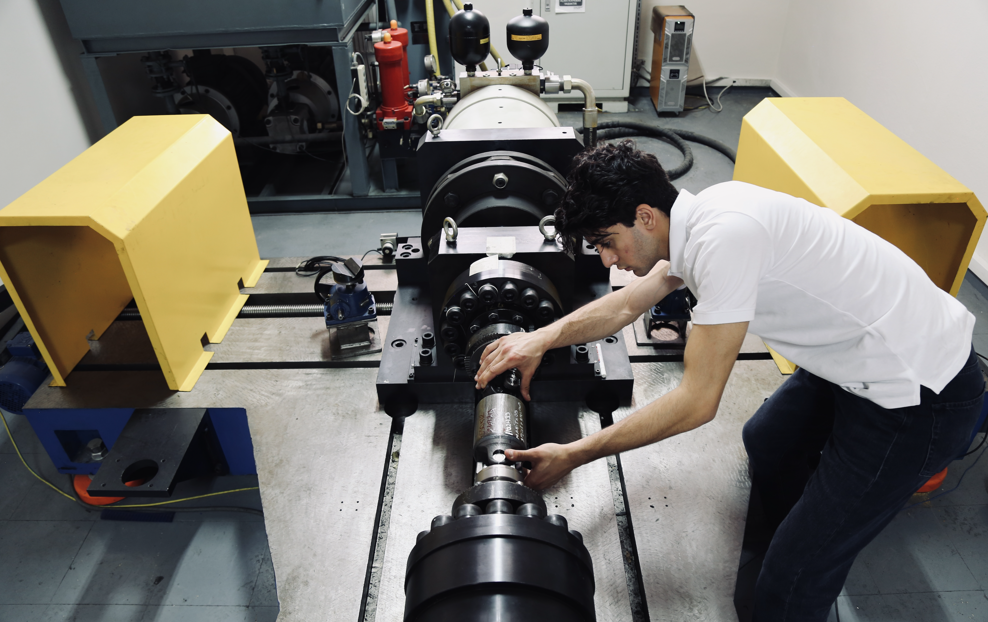 Eren Karapinar working on industrial equipment
